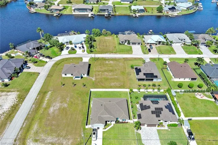 Aerial view of property's location with nearby suburban area and a large body of water