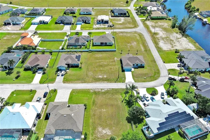 Aerial perspective of suburban area with a nearby body of water