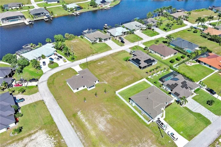 View of property location with nearby suburban area and a nearby body of water