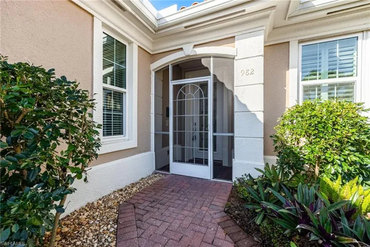 Entrance to property featuring a sunroom and stucco siding