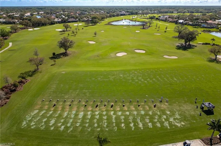 Aerial perspective of suburban area with a nearby body of water and a local golf course