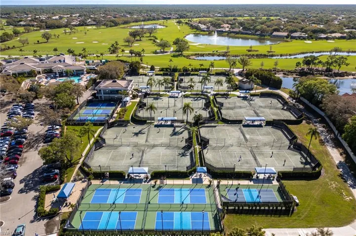 Aerial view of residential area with a local golf course and a nearby body of water