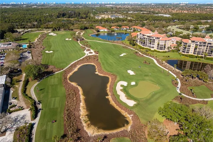Aerial view of property's location featuring a nearby body of water and a golf club