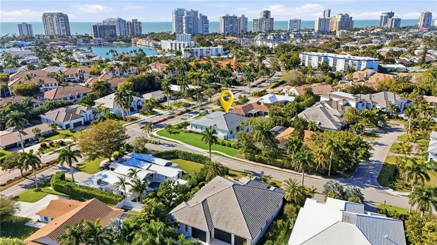 Aerial view of property and surrounding area featuring city skyline and a nearby body of water