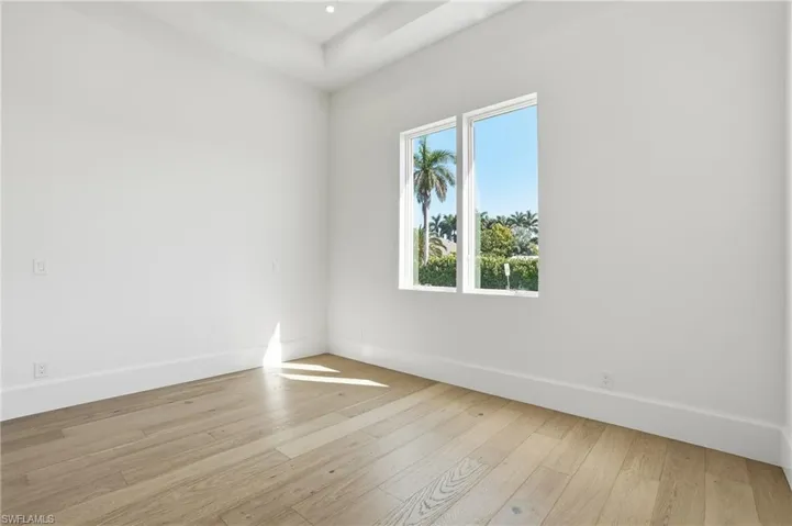 Empty room featuring baseboards and light wood-style floors