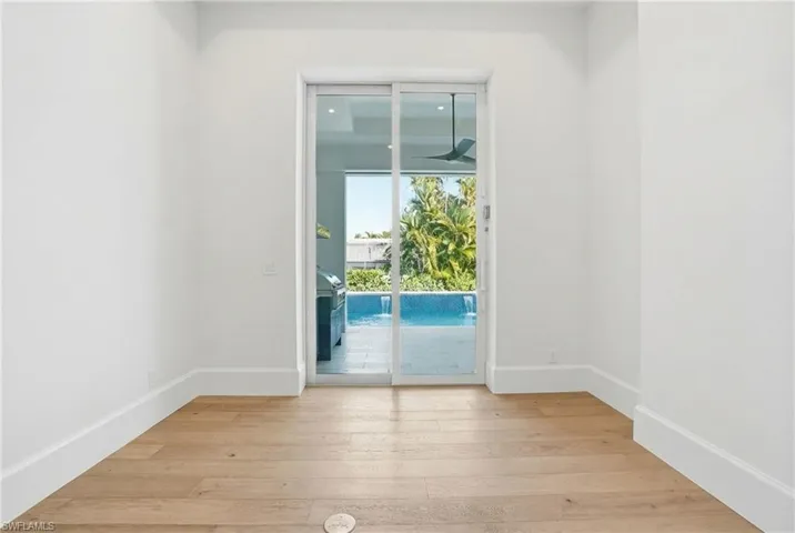 Unfurnished room featuring light wood-style floors and baseboards