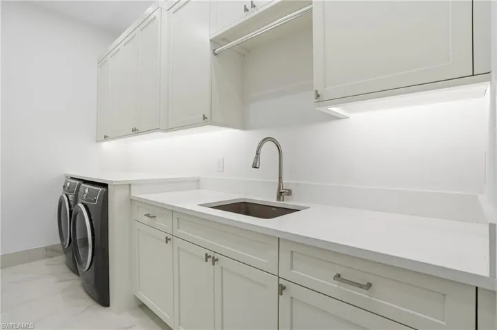 Laundry room featuring washer and dryer and cabinet space