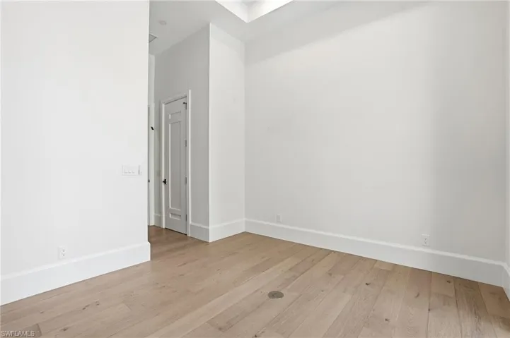 Spare room featuring light wood finished floors and baseboards