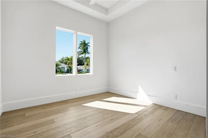 Unfurnished room featuring light wood-style flooring and baseboards
