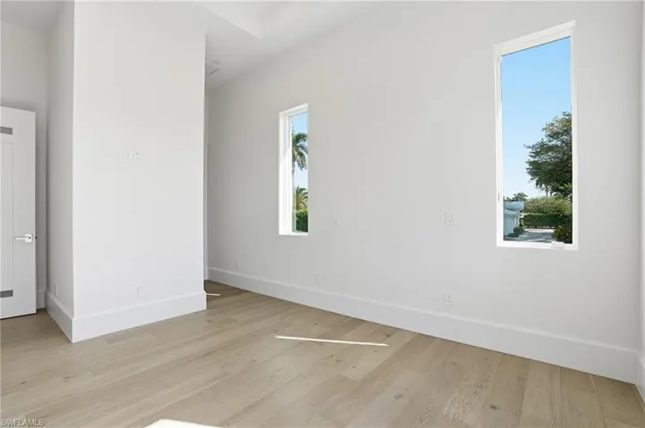Spare room featuring baseboards and light wood finished floors
