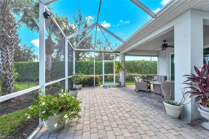 Sunroom featuring a patio and a ceiling fan