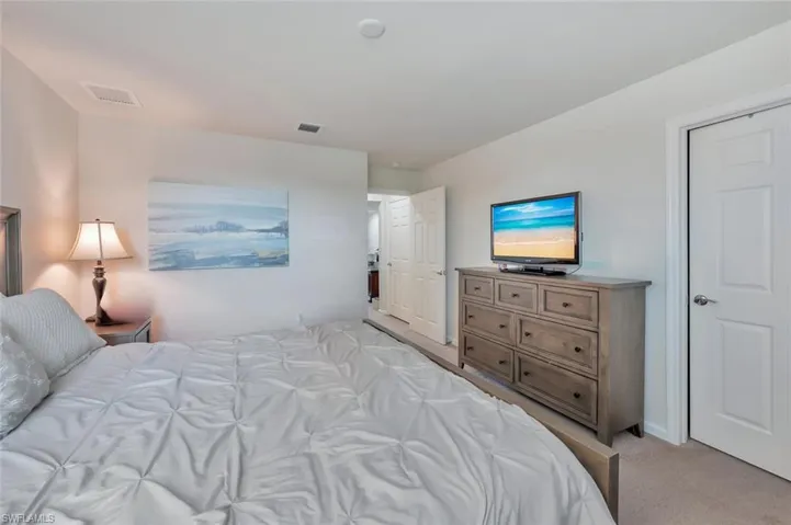 Bedroom with light colored carpet