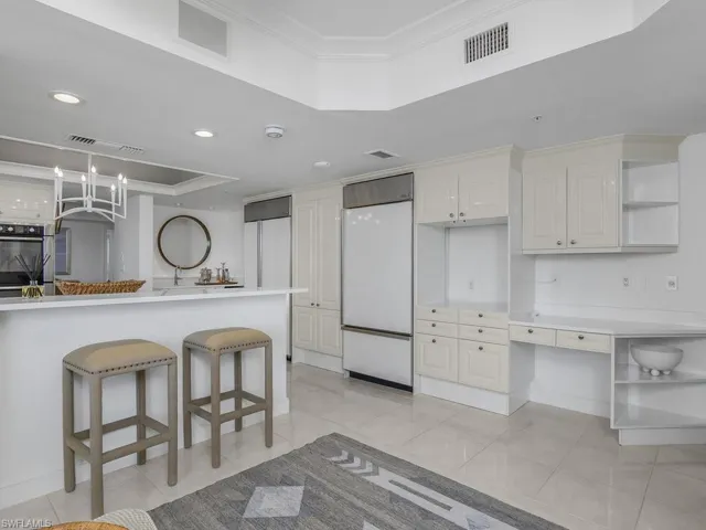 With breakfast bar alongside family room.  Two Sub-Zero refrigerators.