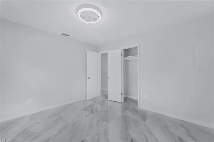 Unfurnished bedroom featuring a closet and a textured ceiling