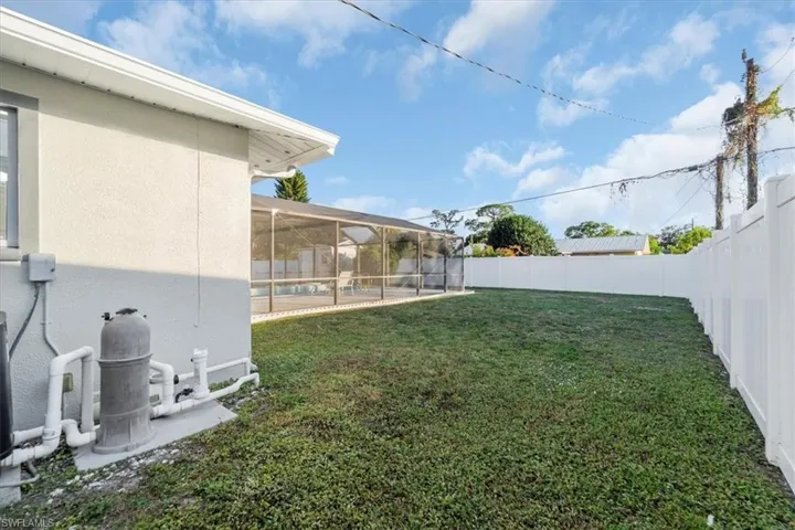 Fenced backyard with a sunroom