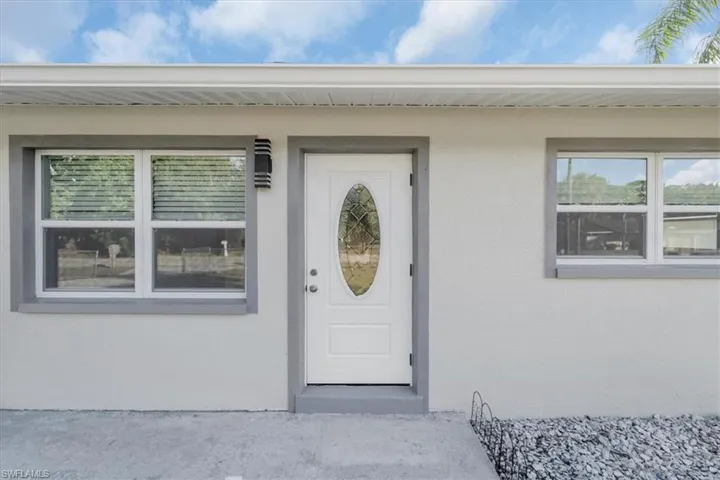 Doorway to property with stucco siding