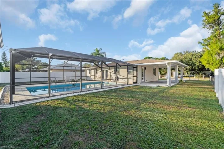 View of swimming pool featuring a fenced backyard, a patio area, a lanai, and a sunroom