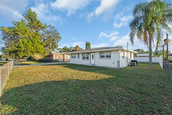 Back of property featuring a fenced backyard and stucco siding