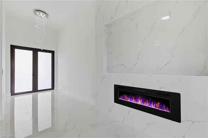 Detailed view of french doors and a high end fireplace