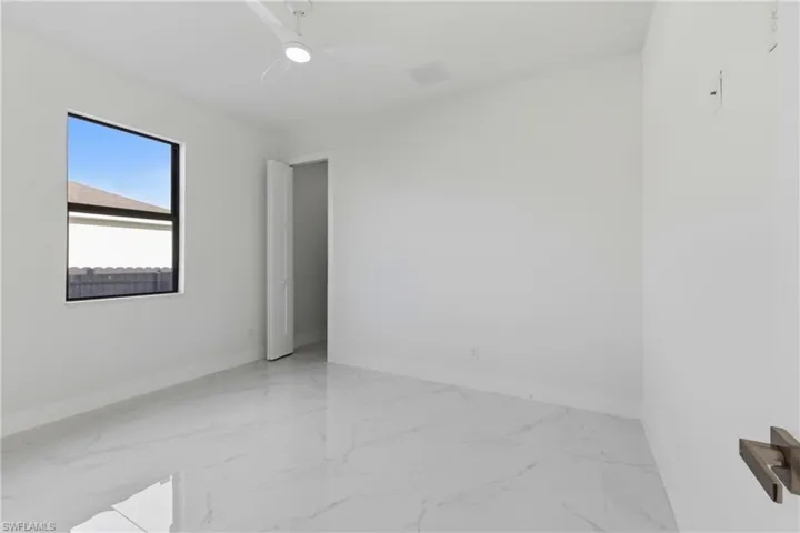 Empty room featuring baseboards and light marble finish flooring