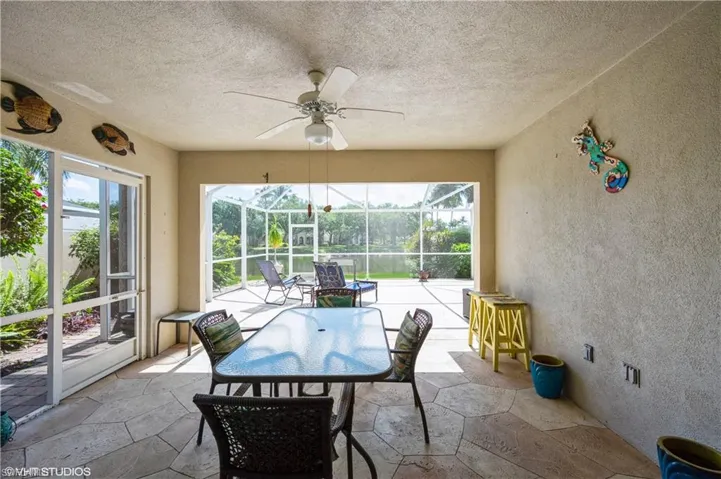 Sunroom / solarium featuring ceiling fan
