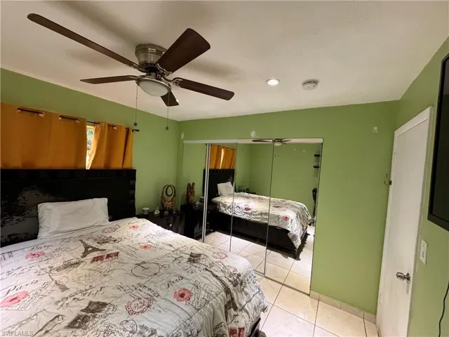 Tiled bedroom featuring a closet and ceiling fan