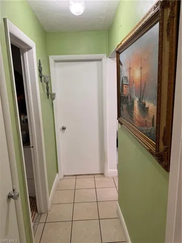 Hall featuring light tile patterned flooring