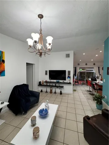 Tiled living room with an inviting chandelier