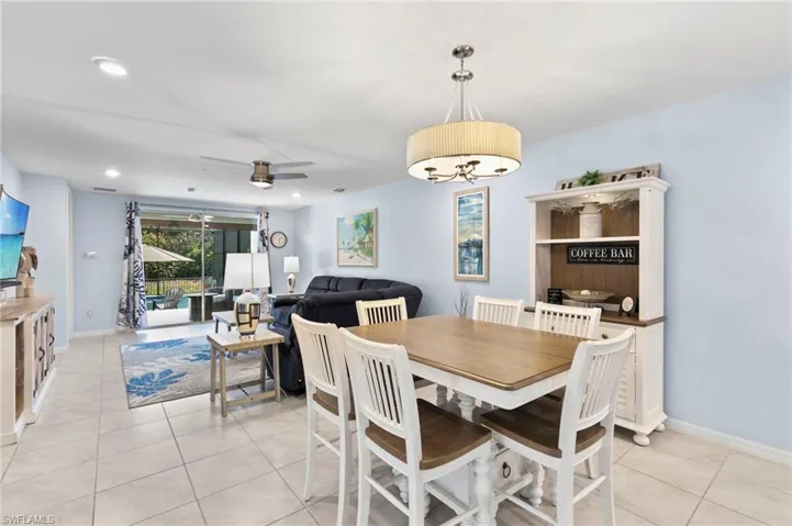 Dining room with ceiling fan, light tile patterned flooring, and recessed lighting