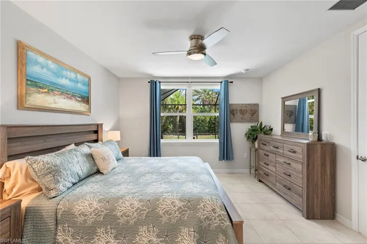 Bedroom with ceiling fan and light tile patterned floors