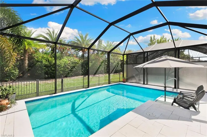View of swimming pool featuring a lanai and a sunroom