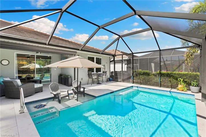 Outdoor pool with a lanai, a sunroom, and a patio
