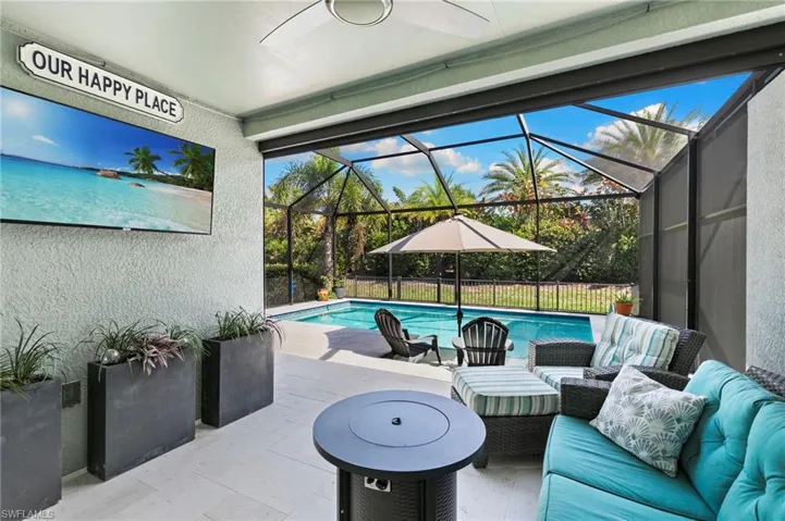 View of patio featuring an outdoor pool, a sunroom, glass enclosure, and an outdoor hangout area