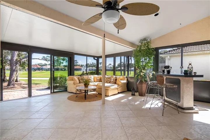 Living area with ceiling fan and light tile patterned floors
