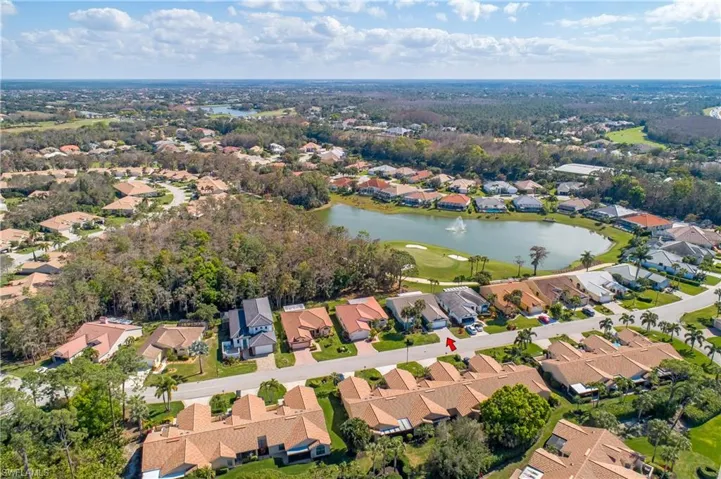 Aerial view of property and surrounding area with nearby suburban area and a nearby body of water