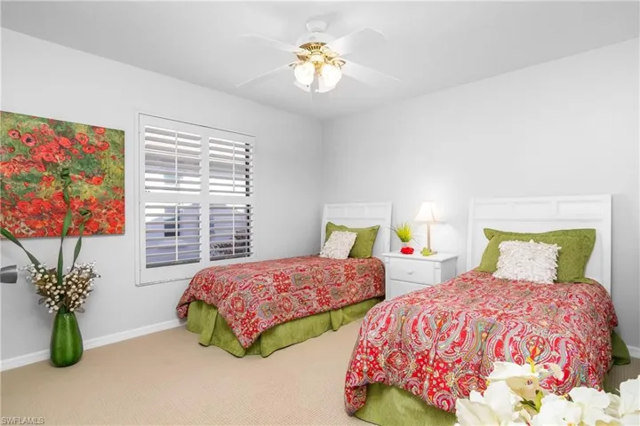 Carpeted bedroom with baseboards and ceiling fan
