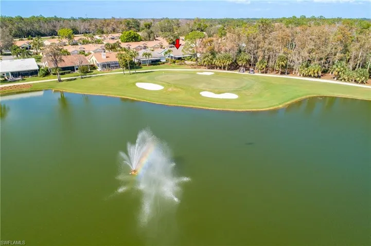 Drone / aerial view of a golf club and a nearby body of water