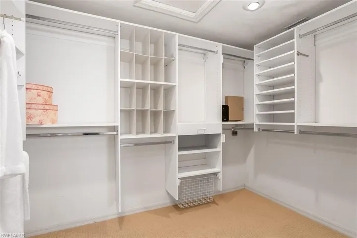 Sunroom / solarium featuring vaulted ceiling, golf course view, a residential view, and tile patterned floors