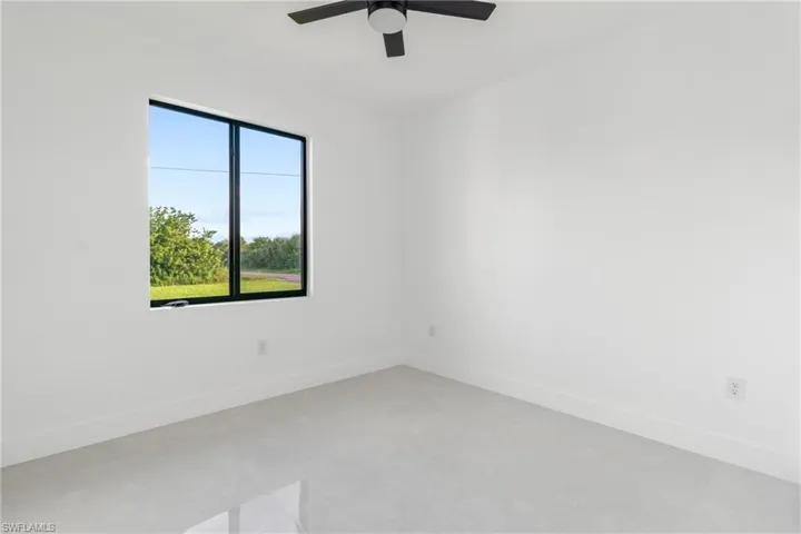 Spare room featuring baseboards and a ceiling fan