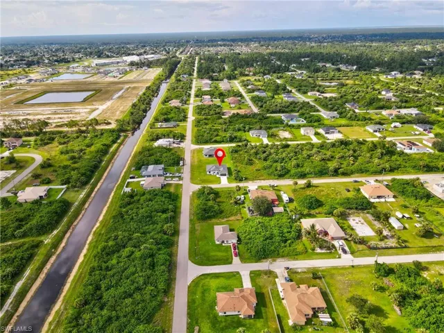 Aerial view of property's location featuring a large body of water and nearby suburban area
