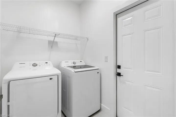 Laundry area with washing machine and clothes dryer