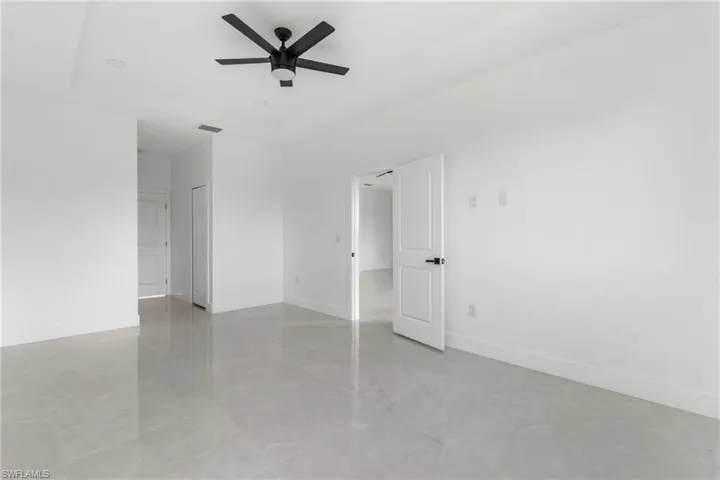 Spare room with baseboards and ceiling fan