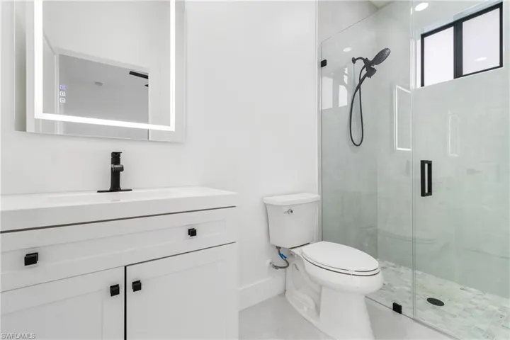 Bathroom with vanity and a shower stall