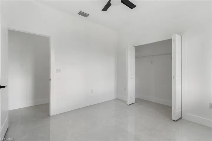 Unfurnished bedroom featuring ceiling fan and a closet