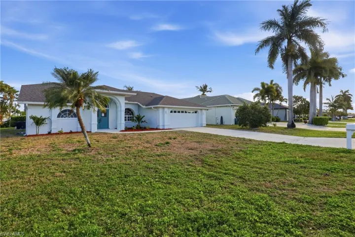 Single-story residence featuring a two-car garage and a paved driveway