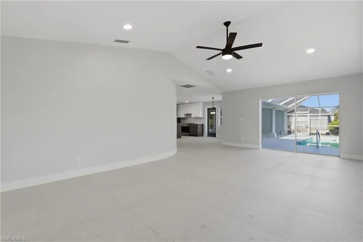 Spacious interior featuring light tile flooring, recessed lighting, and a contemporary ceiling fan