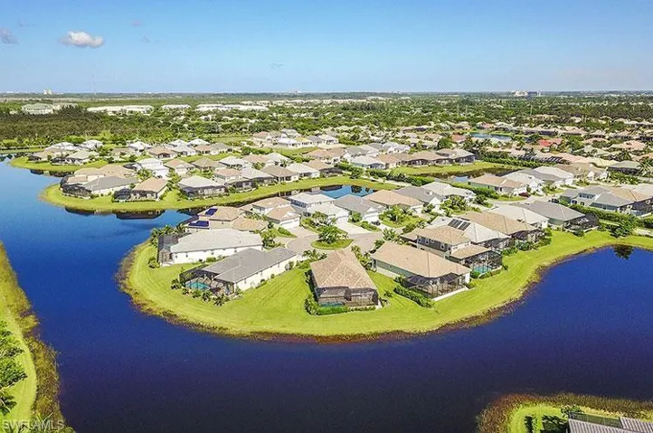Aerial perspective of suburban area featuring a large body of water