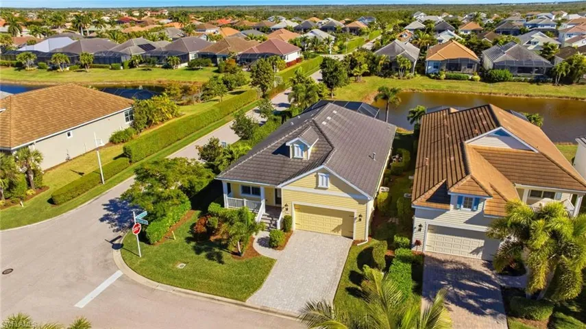 Aerial perspective of suburban area featuring a large body of water