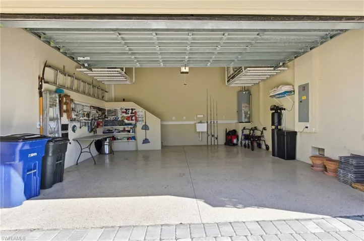 Garage with electric panel and gas water heater