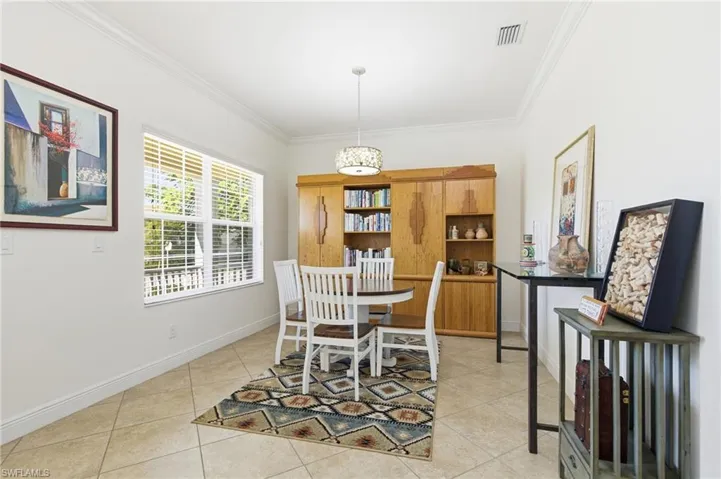 Dining room featuring crown molding and light tile patterned floors